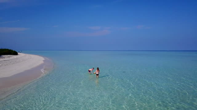 v04196-fliegenden-Drohne-Luftaufnahme-der-Malediven-weißen-Sandstrand-2-Personen-junges-Paar-Mann-Frau-Schwimmen-unter-Wasser-plantschen,-auf-sonnigen-tropischen-Inselparadies-mit-Aqua-blau-Himmel-Meer-Wasser-Ozean-4k