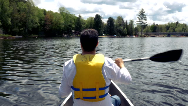 Man-Rowing-Around-Cottage-Country-Ontario