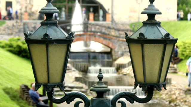 Crowd-people-walk-in-the-park.-Fountain-.-Bridges.-Vintage-street-lamp.