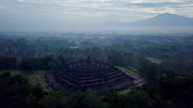 Aerial-view-drone-shot-of-Borobudur-temple-in-Java-at-sunrise,-Indonesia-Travel-religion-drone-concept-4K-resolution