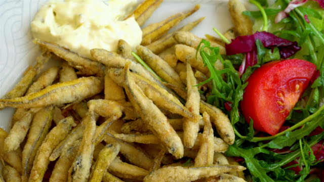 Gegrillte-und-gebratene-kleine-Fische-auf-einem-traditionellen-mediterranen-Teller-garniert-mit-Sommer-Gemüse-und-Obst---Griechenland,-Kroatien,-Italien,-Montenegro,-Tintenfisch.