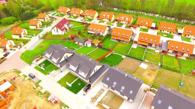 Camera-flight-over-new-family-houses-and-construction-site-in-suburban-district.-Construction-industry-and-economic-growth-in-European-Union.
