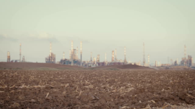 Save-the-plant.-kids-standing-near-a-refinery-wearing-gas-masks
