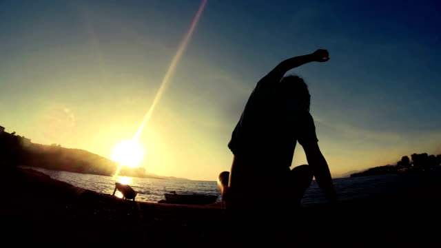 Meditation-near-the-sea-&-doing-yoga-on-a-beach-at-sunrise,-VINTAGE