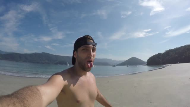 Young-Brazilian-Guy-Having-Fun-and-taking-a-selfie-on-the-beach