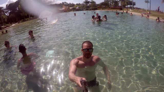 Man-taking-a-selfie-in-a-Pool-in-Queensland,-Australia