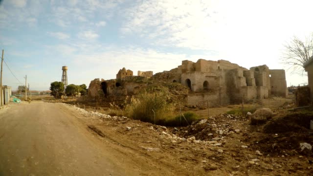 ruins-of-an-ancient-castle-and-a-street-in-a-small-Arab-village,-near-the-border-between-Turkey-and-Syria