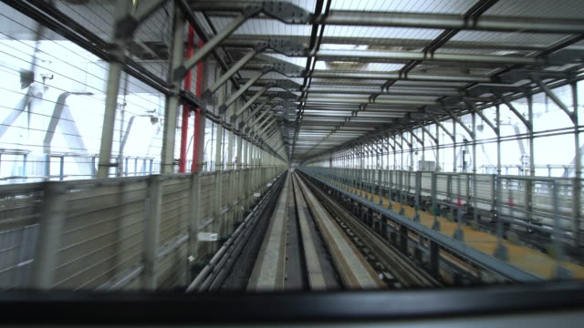 High-speed-bullet-train-going-a-modern-bridge-in-downtown-center-in-Tokyo