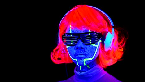 Woman-with-UV-face-paint,-wig,-glowing-glasses,-clothing-portrait,-camera-tilt-upward-to-her-face.-Asian-woman.-.