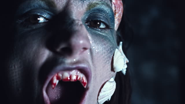 4k-Halloween-Shot-of-a-Horror-Woman-Mermaid-Showing-Bloody-Vampire-Teeth