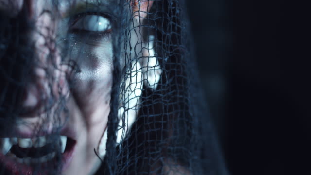 4k-Halloween-Shot-of-a-Horror-Woman-Mermaid-Posing-with-Fangs-and-White-Eyes