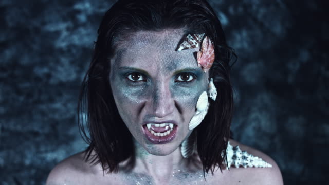 4k-Halloween-Shot-of-a-Horror-Woman-Mermaid-Posing-with-Vampire-Teeth