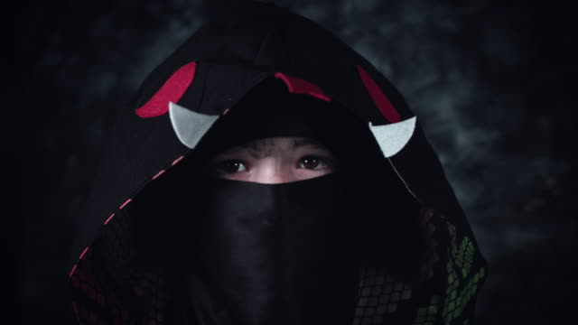 4k-Anime-and-Halloween-Shot-of-a-Child-in-Ninja-Costume-Showing-Sign