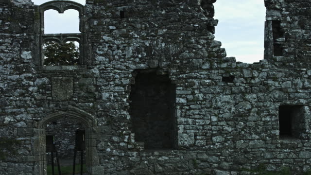 4k-Horror-Shot-of-an-Abandoned-Child-Appearing-in-the-Window-of-a-Ruined-Castle