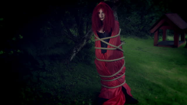 4k-Halloween-Shot-of-Red-Riding-Hood-Tied-with-Ropes