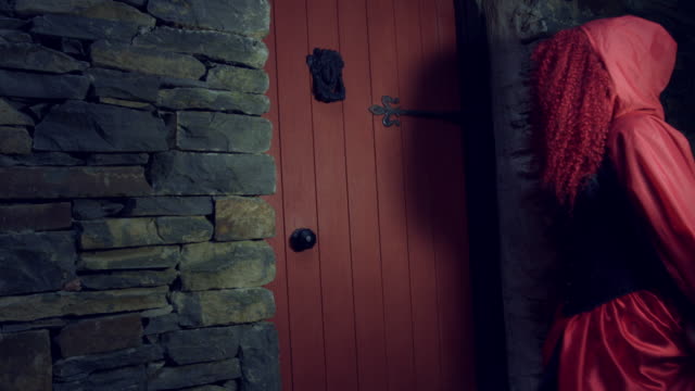 4k-Halloween-Shot-of-Red-Riding-Hood-Knocking-on-the-Door