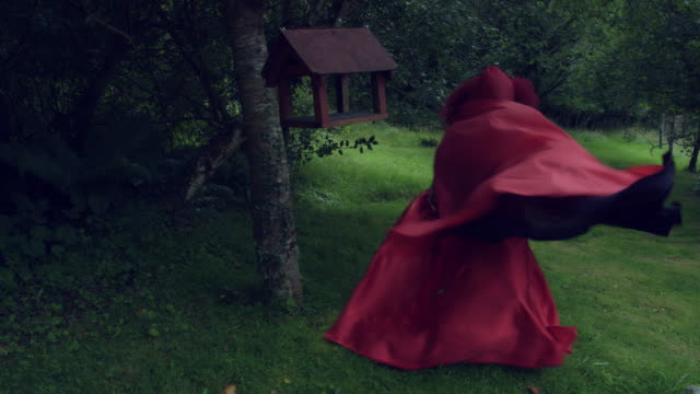 4k-Halloween-Shot-of-Red-Riding-Hood-running-Scared-in-Woods
