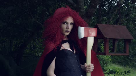 4k-Halloween-Shot-of-Red-Riding-Hood-Posing-with-an-Axe