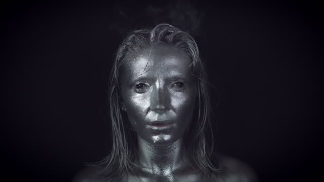 4K-Horror-Woman-with-Silver-Metallic-Make-up-Smoking-in-Reverse