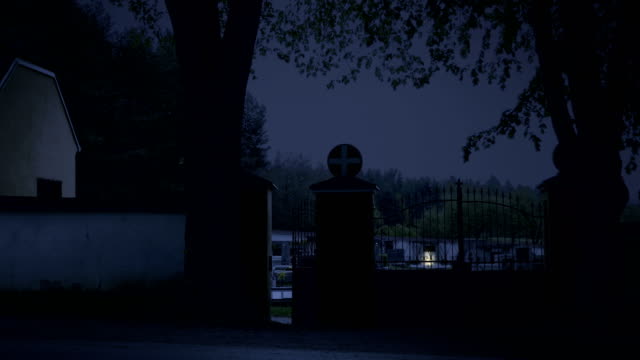 Scary-cemetery,-night.-Invisible-spirit-closes-and-opens-graveyard-gate.