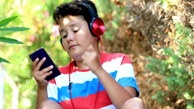 Young-boy-listeninng-to-music-at-the-nature
