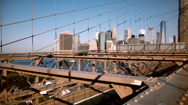 Beautiful-perspective-view-of-Manhattan-skyscrapers-from-Brooklyn-Bridge-through-amazing-metal-net-construction-4K