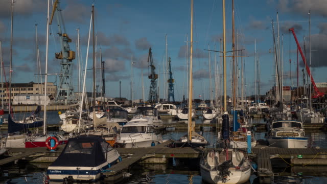Timelapse-of-Marina-with-floating-boats-in-Wismar,-Germany-with-epic-clouds-during-sunny-weather
