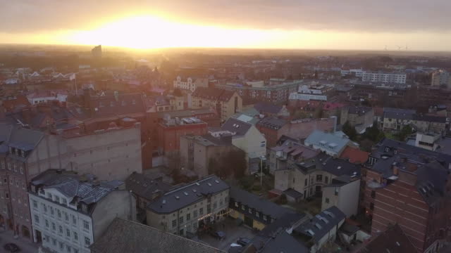 Aerial-view-of-Lund-city,-Sweden.-Drone-shot-flying-over-Lund-cityscape-at-sunset