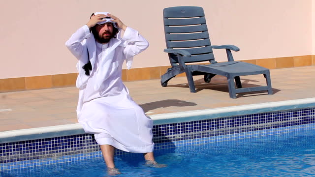 Saudi-arabian-man-enjoying-at-swimming-pool