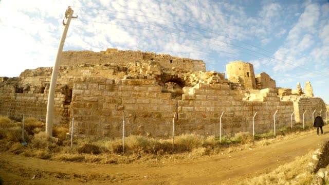 a-ruined-medieval-castle-Harran-Kalesi-fenced-off,-close-to-the-border-between-Turkey-and-Syria
