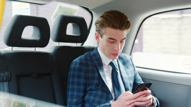Stilvollen-Mann-Anzug-mit-Handy-im-Taxi-Cab