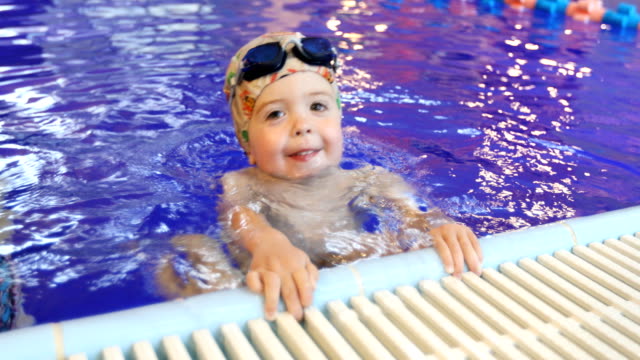 Portrait-of-little-baby-swimming-in-swimming-pool