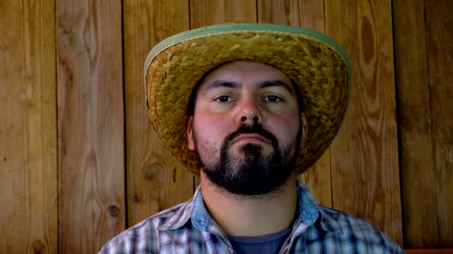 Man-in-straw-hat-on-wooden-background