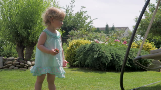 Cute-Toddler-Girl-Near-Hammock-in-Backyard-Garden