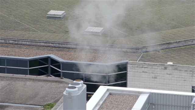 Steam-and-Smoke-Bellows-From-a-Chimney-Atop-a-HighRise-Building