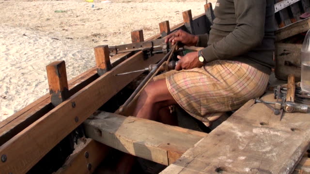 Craftsman-making-a-boat-with-primitive-tools-in-Varanasi