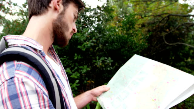Close-up-of-hiker-looking-a-map