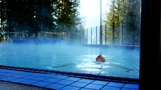 Woman-relaxing-in-swimming-pool