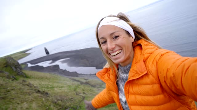 Selfie-of-girl-at-Hvitserkur-basalt-stack-along-the-eastern-shore-of-the-Vatnsnes-peninsula,-in-northwest-Iceland.-People-travel-lifestyles-concept