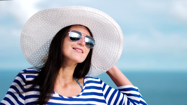 Slow-motion-woman-admiring-beautiful-sky-reflecting-in-sunglasses-and-seascape