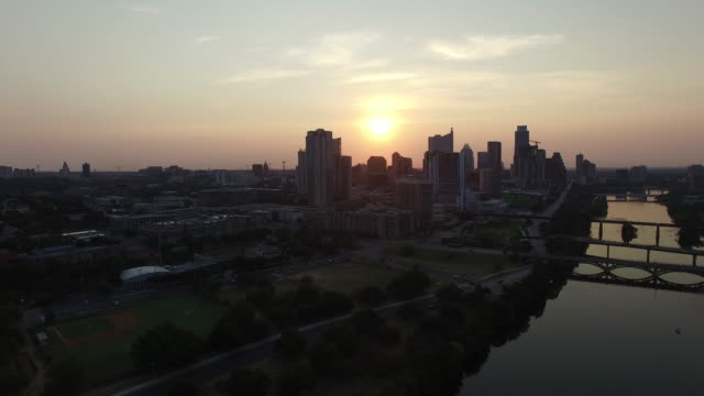 Aerial-view-of-sunset-sun-setting-over-Austin,-Texas,-USA