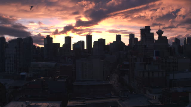 Aerial-View-flying-over-downtown-Vancouver-at-sunset