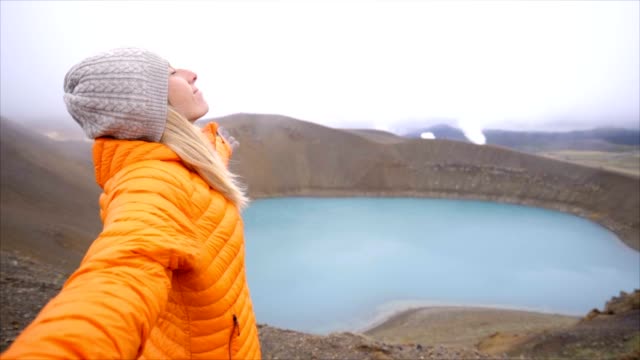 Slow-motion-Young-woman-arms-outstretched-at-spectacular-crater-lake-in-Iceland