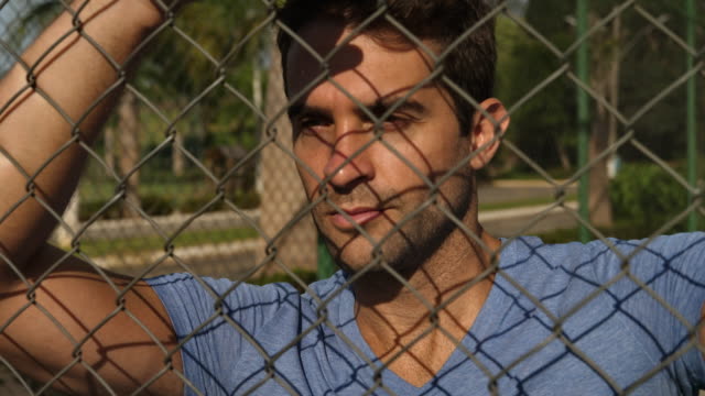 Guy-leaning-against-fence
