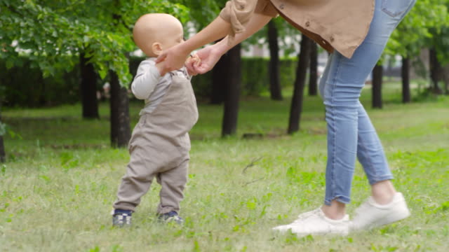 Mother-Teaching-Baby-Boy-to-Walk