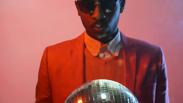 Black-Man-with-Disco-Ball-on-Pink-Background