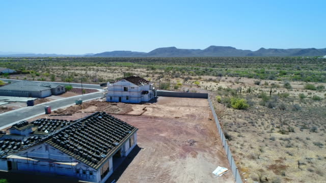 Aerial-Arizona-New-Home-Construction-Site-and-Highway-Fly-Left