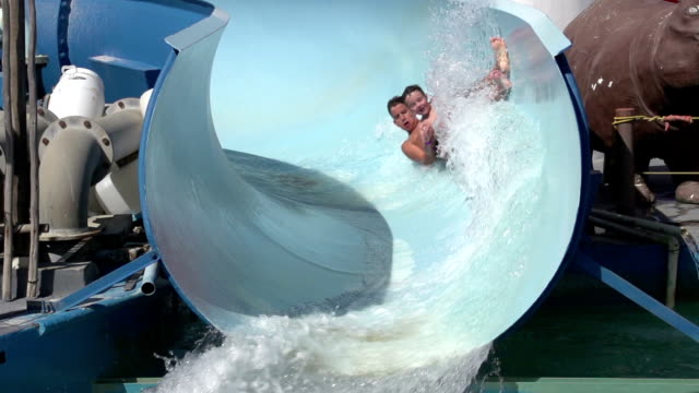 Slow-motion-of-2-happy-boys-sliding-on-water-slide,-Cape-Town,-South-Africa