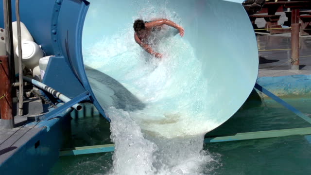 Slow-motion-of-happy-boy-on-water-slide,-South-Africa