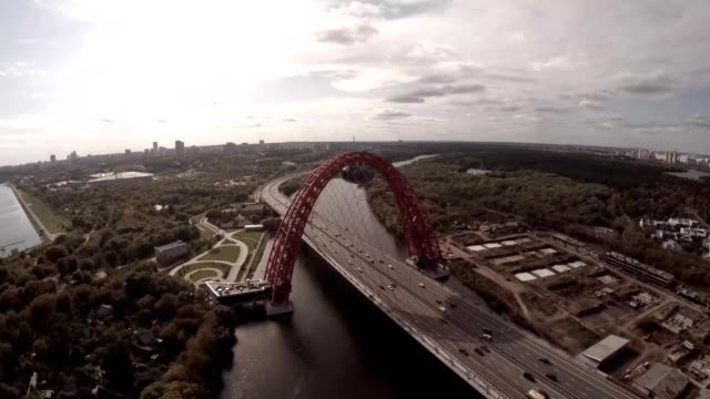 Aerial-helicopter-view-of-Zhivopisnyi-Most-(trsl.-Picturesque-Bridge)-over-Moscow-River.-Moscow-Russia.-Zhivopisny-Bridge-is-a-cable-stayed-bridge-that-spans-Moskva-River-in-north-western